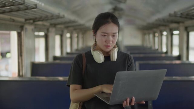 Traveler working on a laptop inside a train, ideal for remote work, digital nomad lifestyle, business travel, productivity, rail journey and mobile office concepts.