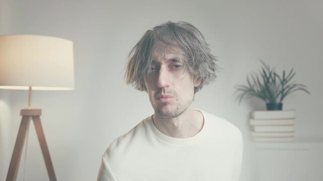 Young man making expressive facial reactions, casual lifestyle portrait indoors