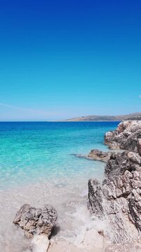 Vertical View Of Crystal Clear Turquoise Water Rocky Coast And Blue Sky, Himare - Albania.