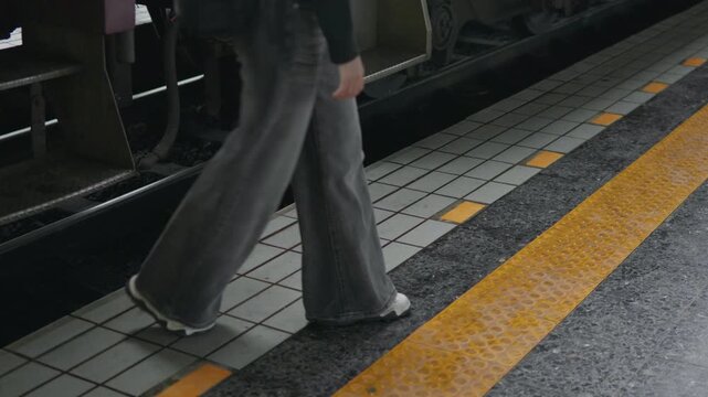 Passenger boarding a train at railway platform, ideal for public transport, rail travel, commuting, departure, journey and travel safety concepts.