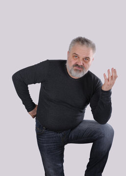 Thoughtful mature man explaining something with hand gesture
