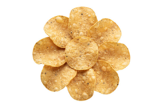 View of crispy round corn tortilla chips arranged in a flower pattern on a plain , for food projects