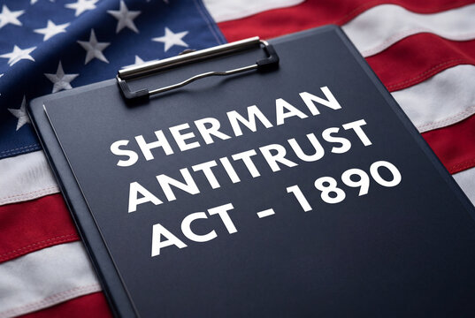 Sherman antitrust act 1890 document on a clipboard over an american flag background