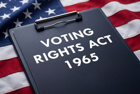 Voting rights act 1965 text on a clipboard placed on a united states flag background