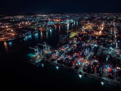 Industrial Shipping Terminal Illuminated At Night Featuring Gantry Cranes And Cargo Containers In Laem Chabang Chon Buri Thailand