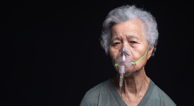 Senior woman using oxygen support for respiratory care