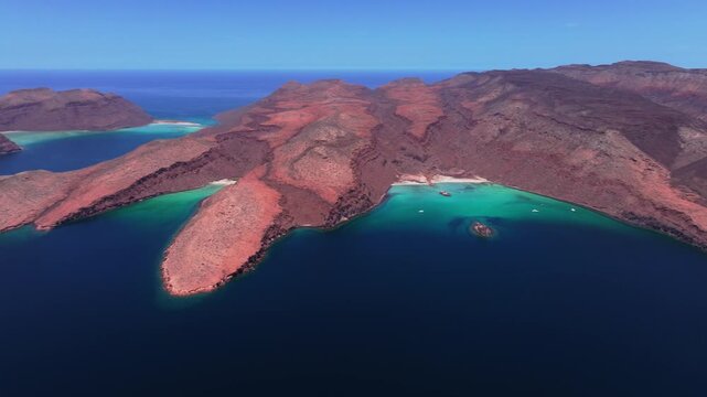 Stunning drone perspective of the pristine turquoise waters and unique volcanic rock formations of Isla Esp&iacute;ritu Santo in Baja California Sur, Mexico.