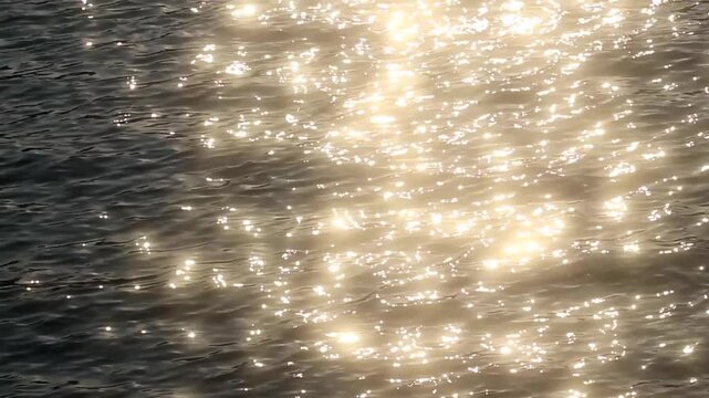 Golden sunlight sparkles on calm ocean waves at sunset, creating a dreamy summer background with shimmering reflections, peaceful atmosphere, and natural beauty.