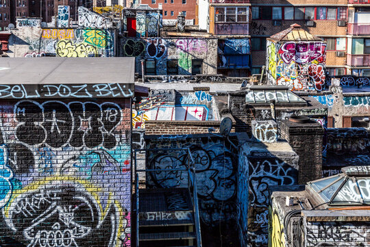 Chinatown  graffiti-covered urban walls and rooftops showcase vibrant street art and city exploration, highlighting the gritty industrial spirit of Lower Manhattan, New York City.