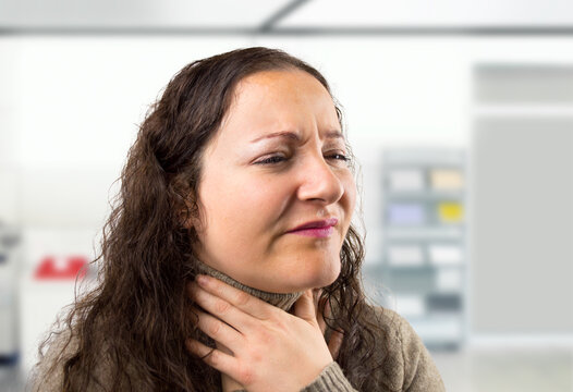 Stress, sick and businesswoman in office with throat pain, injury or accident for allergies. Medical emergency, health care and female creative designer with laryngitis for cold or flu in workplace.
