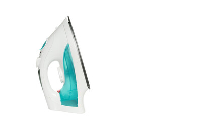 cordless iron of turquoise color stands vertically sideways in the left part of the frame © Родион Бондаренко