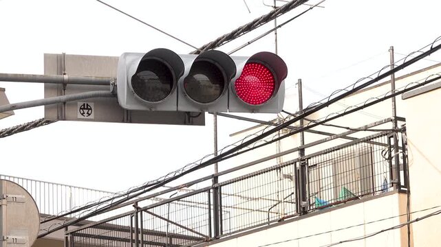 Japanese traffic light changing from red to green on an urban street