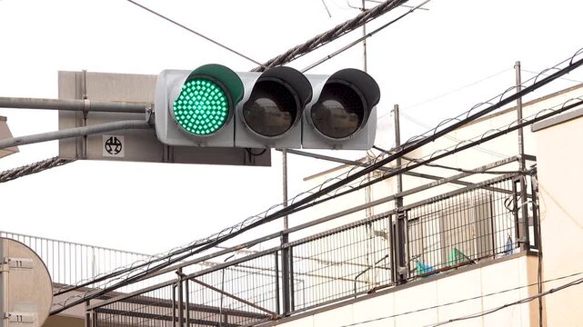 Japanese traffic light changing from green to yellow to red