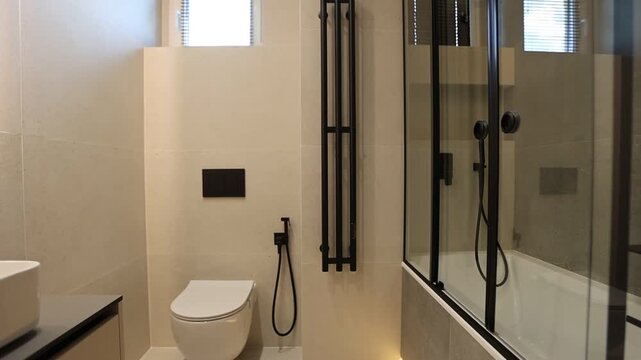 Modern minimalist bathroom interior with wall-mounted toilet and glass shower enclosure