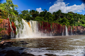 Paredao Waterfall in Apui, Amazonas, Brazil. Majestic 16-meter cascade surrounded by pristine tropical rainforest jungle, ideal for sustainable ecotourism, nature travel and conservation. © rafael