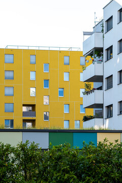 yellow apartment buildings rise above greenery in Nordbahnviertel Vienna Austria as balconies and windows shape the facade of urban housing