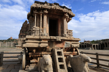Fototapeta premium Ancient stone architecture of the Vittala Temple complex in Hampi, Karnataka, India, featuring intricately carved pillars, ornate mandapas, and the artistic legacy of the Vijayanagara Empire