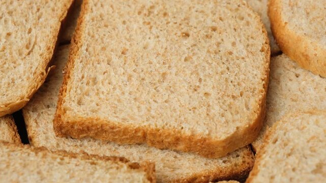 Food background with spinning whole wheat grain bread slices
