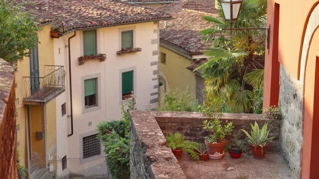 Beautiful picturesque quintessential small italian town or village in summer. Colorful small medieval buildings and houses during vacation or holiday in peaceful village. Quiet street balconies