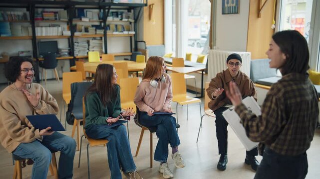 Group of students participate in a discussion in a library on a weekday afternoon