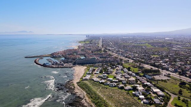 Drone view down Gordon's Bay coastline toward Harbour Island Marina in False Bay