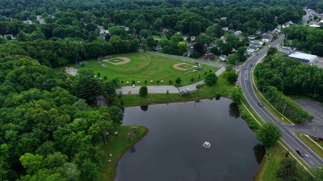 Softball Fields And Pond At Heritage Park In Longmeadow, Springfield, Massachusetts, USA. - aerial pullback shot