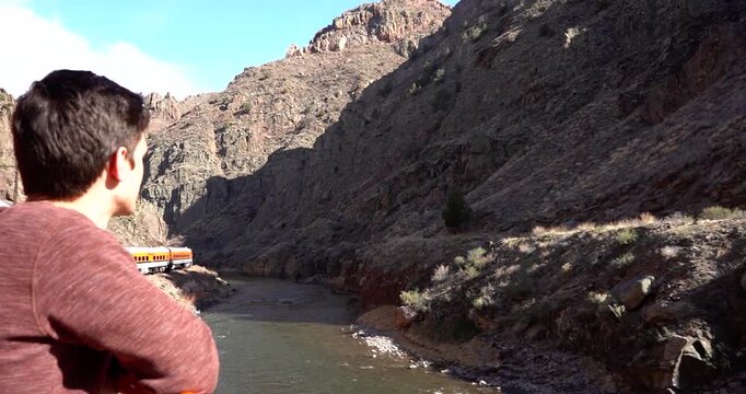 Man admiring Royal Gorge, Colorado scenery from railroad observation car