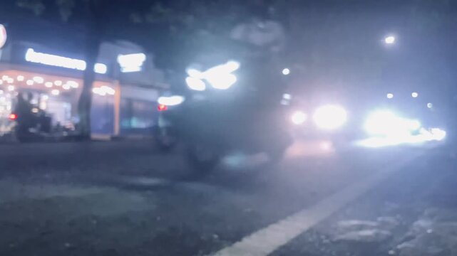 Blurred vehicle movement on highway at night, dynamic urban transportation scene with light trails, motion blur effect and city traffic concept.