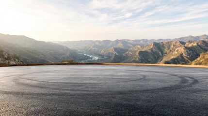 Naklejka premium Scenic mountain vista with paved asphalt surface and tire marks, ideal for automotive or travel themes