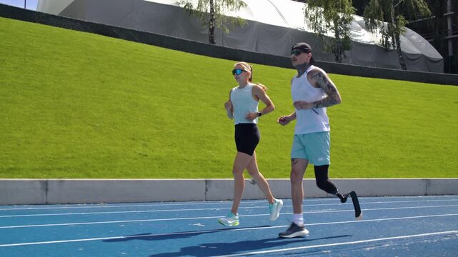 Woman instructor trains sprinter with bionic leg prosthesis