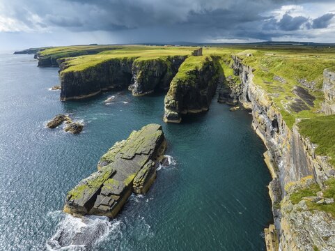 Aerial view of the ruined Castle of Old Wick surrounded by rugged cliffs on the North Sea coast, Wick, County Caithness, Scotland, United Kingdom