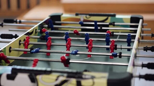 Foosball game taking place in a busy cafe with players focused on the match and enjoying their time