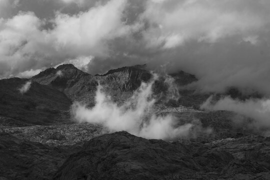 View over the Steinernes Meer Plateau to the summit of the Funtenseetauern with moving clouds, monochrome, Berchtesgaden Alps, between Bavaria and Austria