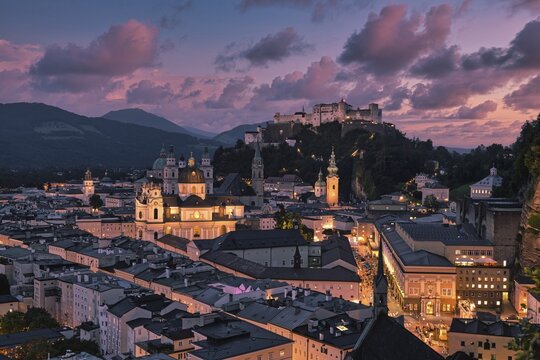 Salzburg's illuminated night view with the fortress and Alpine panorama, captured in the soft glow of lights, Salzburg, Salzburger Land, Austria