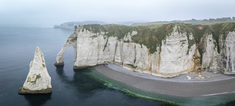 Aerial view of La Porte d'Aval and l'Aiguille on the Alabaster Coast in light fog, Etretat, Normandy, France