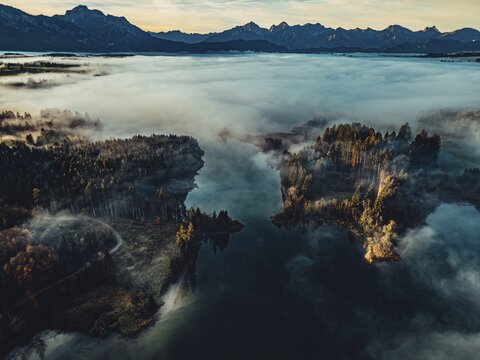 Autumn sunrise in the foothills of the Alps with fog at Illasbergsee and Forggensee near Halblech in Allg&auml;u, Bavaria, Germany