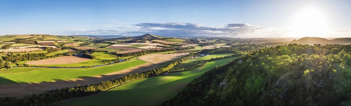 Panorama of evening Fields and Farms over River Teviot and Minto Crags from a drone, Roxburghshire, Scottish Borders, Scotland, UK