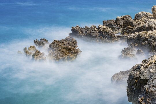 Romantic view over the sea in Koromačna Bay on a sunny day with rough seas on the island of Cres, long exposure, Croatia