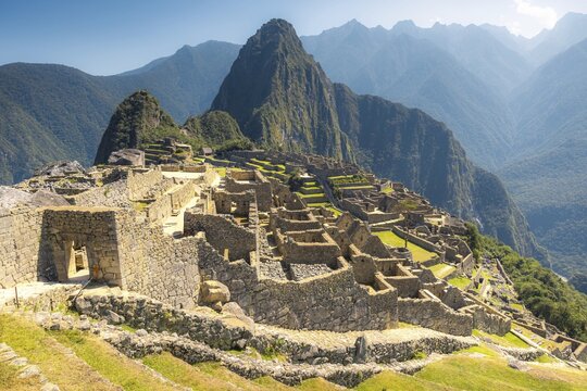 Ancient Inca ruins in Machu Picchu surrounded by majestic mountains in the Andes, Peru
