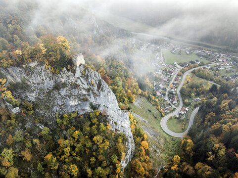 Aerial view of the viewpoint, shovels and Hausen Castle, also known as the Hausen ruins, surrounded by autumnal vegetation and clouds of fog, a ruin of a castle above the village of Hausen in the valley in the Upper Danube Valley, Beuron, Sigmaringen district, Baden-W&uuml;rttemberg, Germany