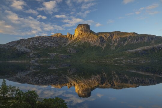 Morning dream over the quiet Steigtindvatnet near Bod&oslash;. Pine forest on the rock face at sunrise