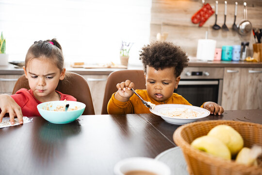 Family breakfast brings joy to cheerful kids at home