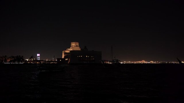 Illuminated Museum of Islamic Art and Dhow Silhouettes at Night in Doha