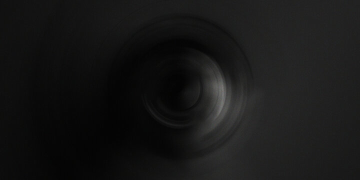 Dark circular abstract art with deep shadows and soft vignette light emanating from center creates moody mysterious atmosphere.