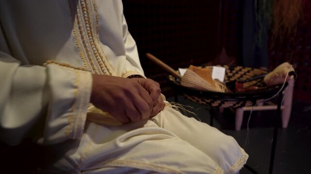 Close-Up of Artisan Hands Weaving Traditional Handmade Shoes