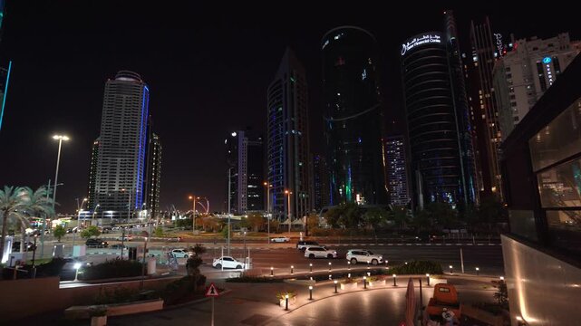 Doha West Bay Skyline at Night with Modern Architecture and Traffic
