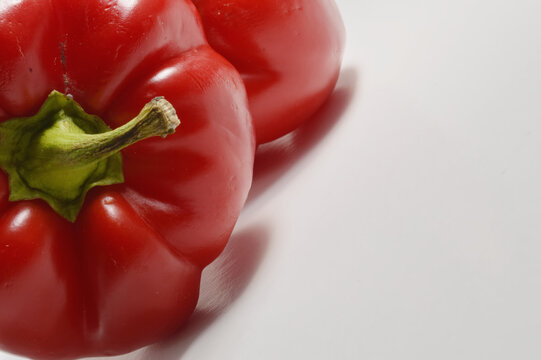 Red bell pepper against clean white background with generous copy space, red pepper culinary overlay, pepper photo for branding