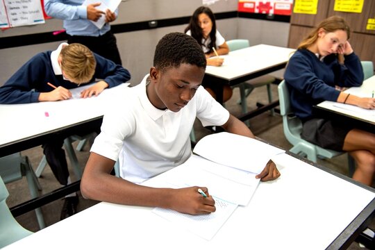Students focused during classroom exam.
