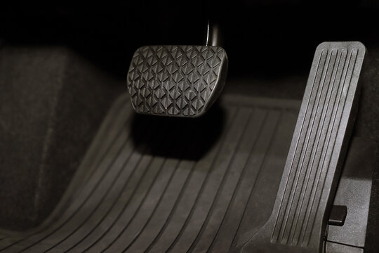 Closeup pedal of car brake. To slow down, stop the car both normal and abruptly, transfer the weight to press the front wheels to grip the road and turn more stable.	