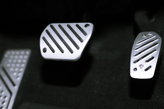 Closeup pedal of car brake. To slow down, stop the car both normal and abruptly, transfer the weight to press the front wheels to grip the road and turn more stable.	